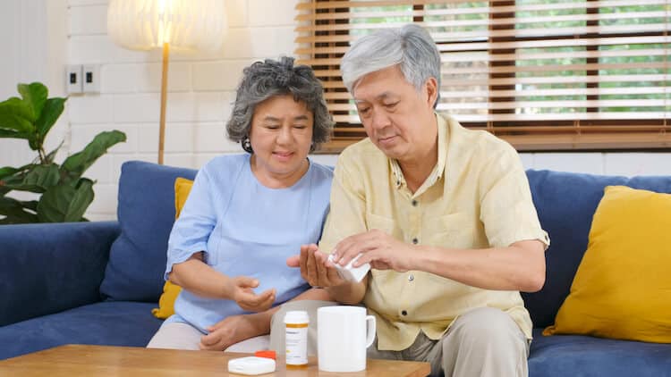 Senior couple taking prescription medications.