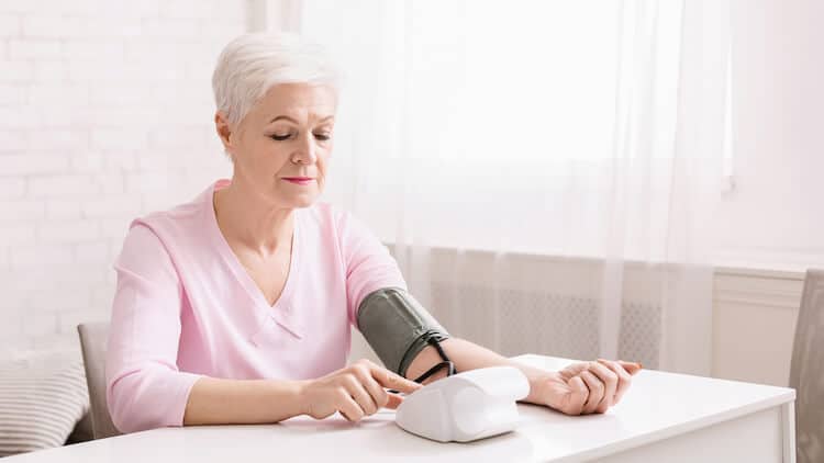 Senior woman checking blood pressure.
