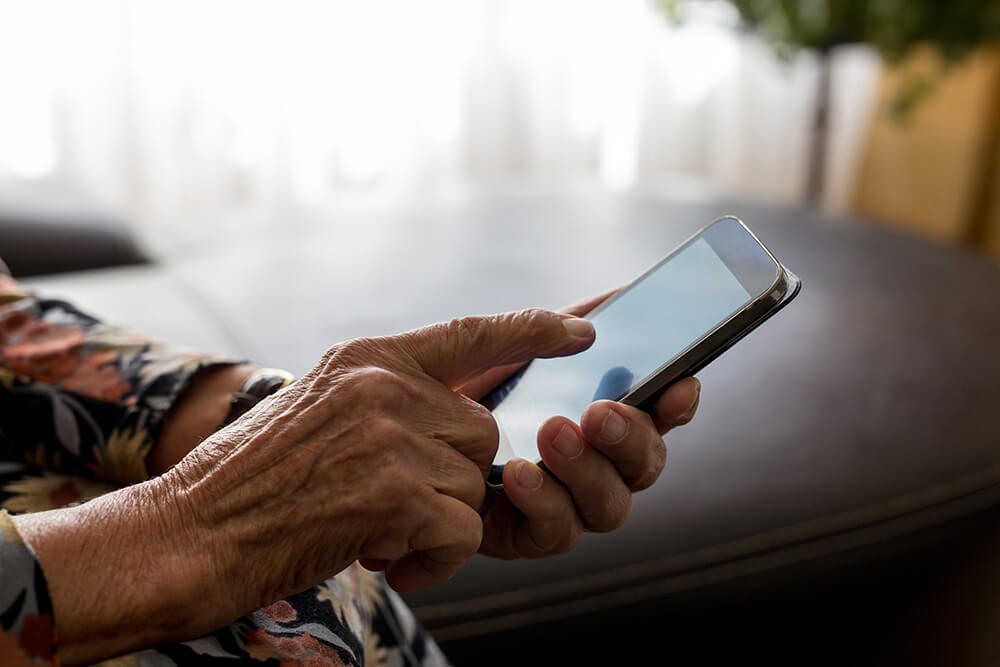 aged hands using a mobile phone