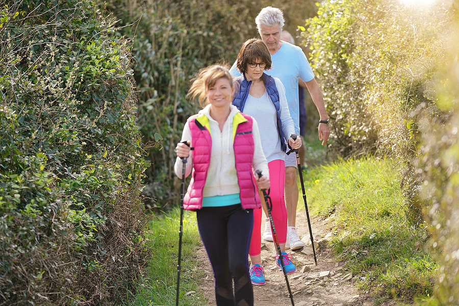 A group of seniors embrace Nordic walking by the Atlantic Coast.