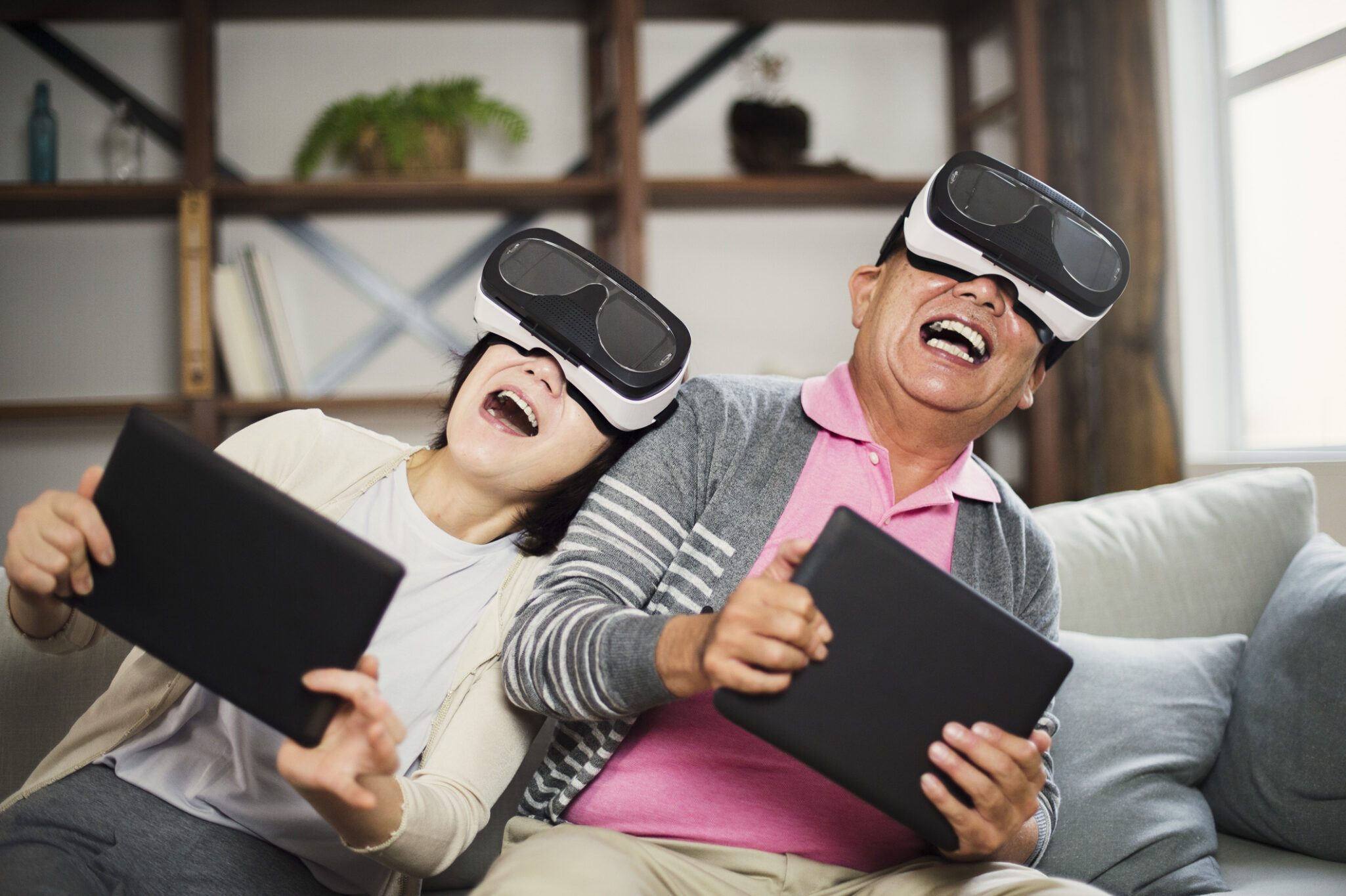 Elderly couple trying out some virtual reality headsets