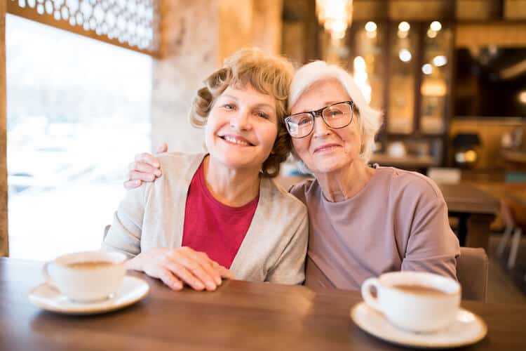 Senior women enjoying coffee in a café.