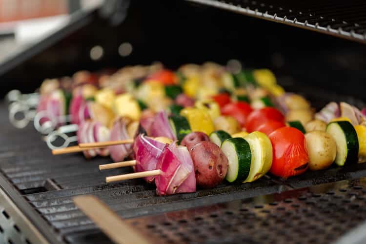 Veggie kabobs on a grill.