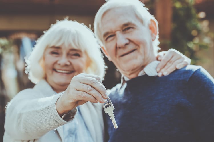 senior couple holding keys