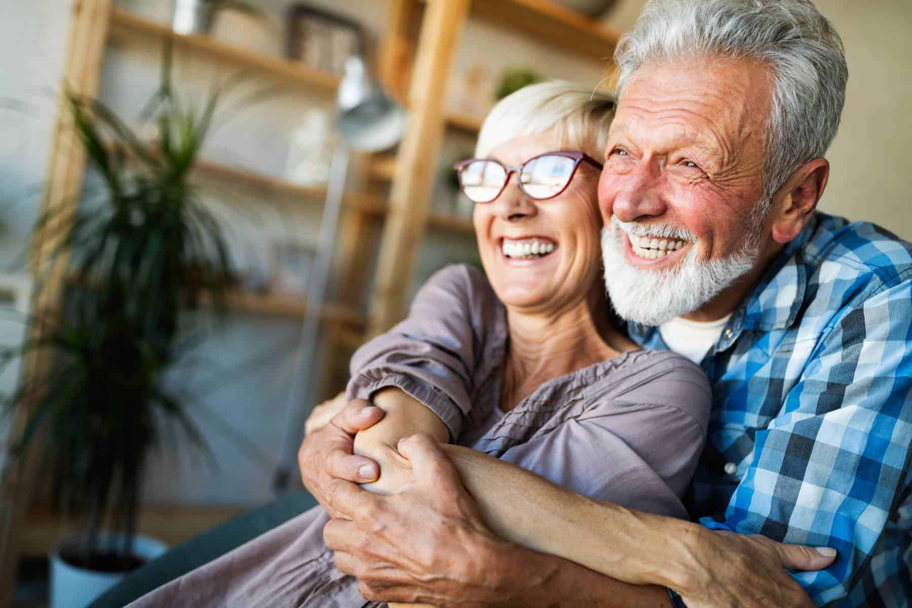senior couple smiling and hugging