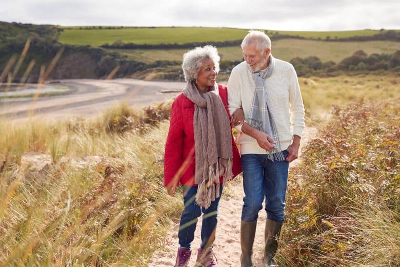 A senior couple taking a stroll near their CCRC home together.