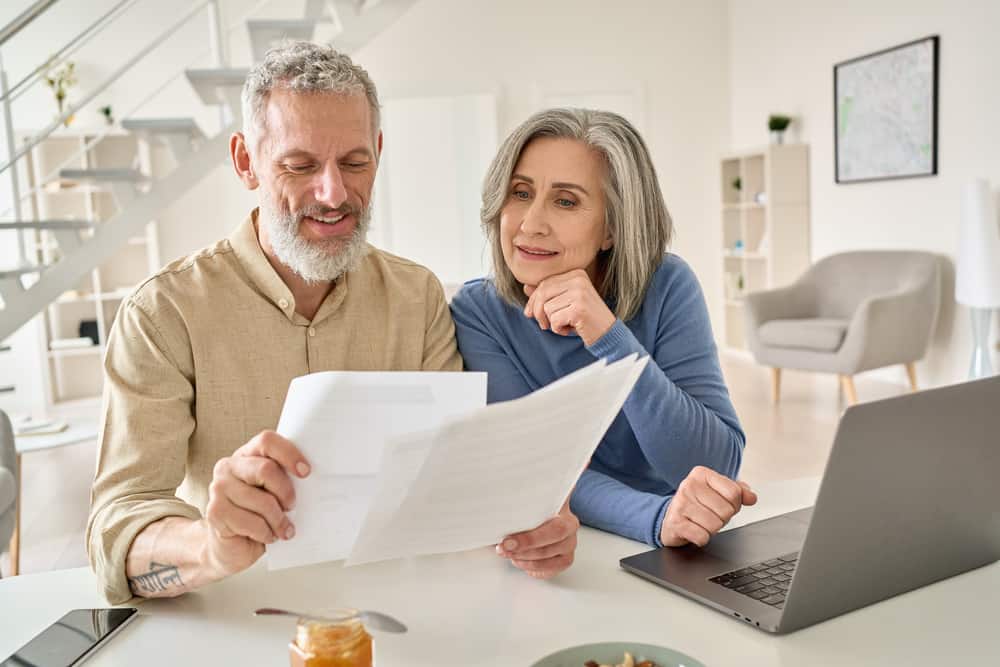 A senior couple look at paperwork