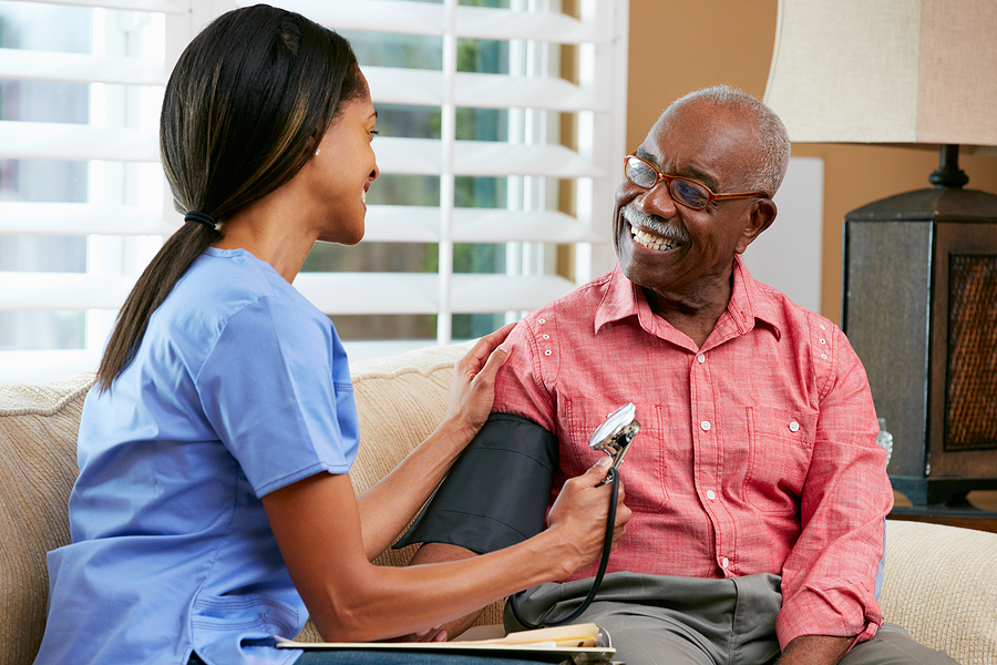 Nurse visiting a senior male patient at home