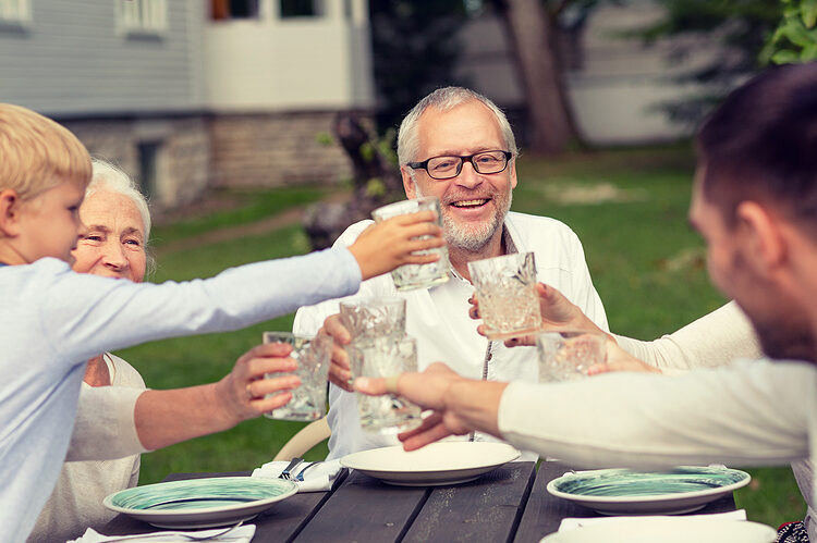 Family sitting outside and having dinner together