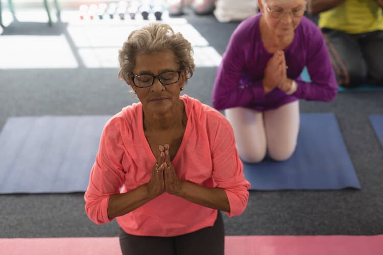Senior woman taking a yoga class.