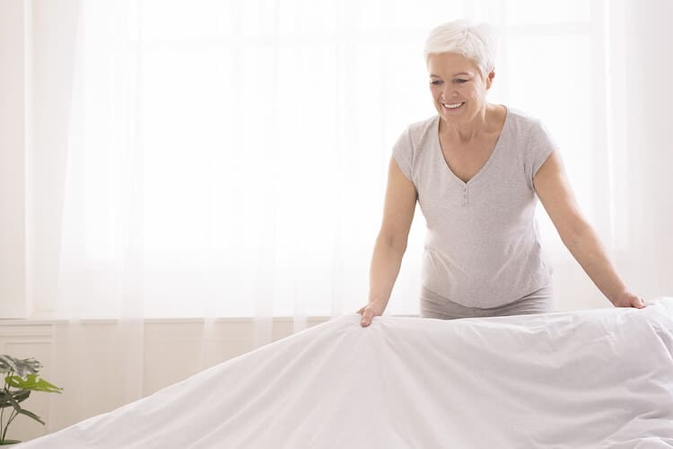 Senior woman cleaning and staging her home to sell.